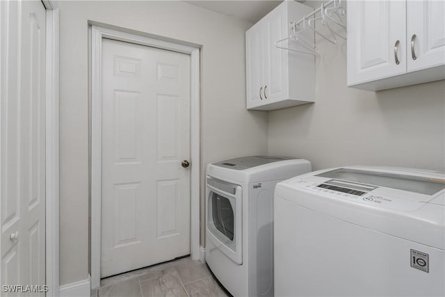 laundry room with cabinet space and washing machine and clothes dryer