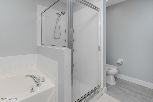 full bathroom with toilet, a stall shower, baseboards, and a bath