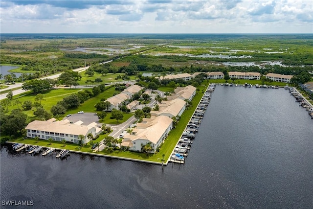 birds eye view of property with a water view and a residential view