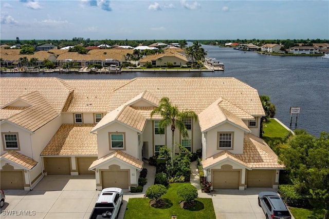 drone / aerial view with a water view and a residential view