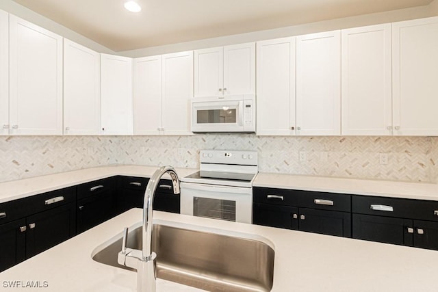 kitchen featuring white cabinets and white appliances