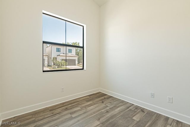 empty room with wood-type flooring