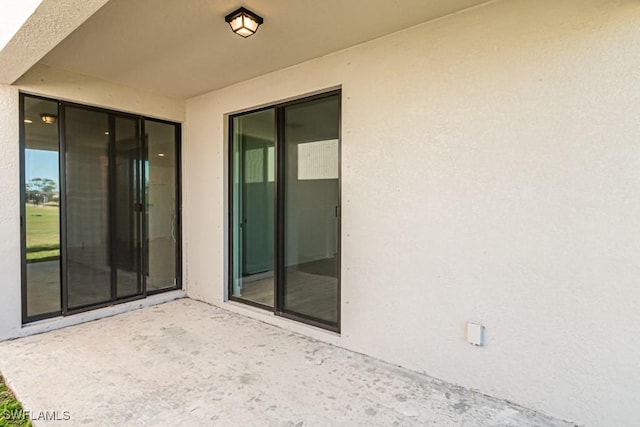 property entrance with a patio