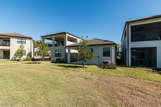 rear view of house with a yard