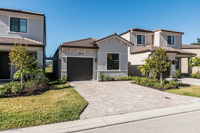 view of front of home with a garage and a front lawn