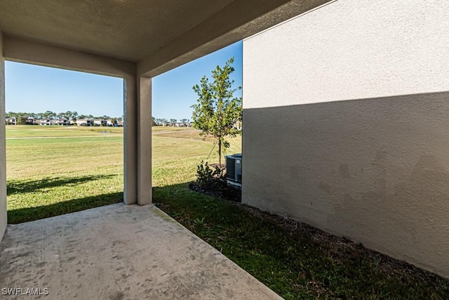 view of yard with central AC unit and a patio area