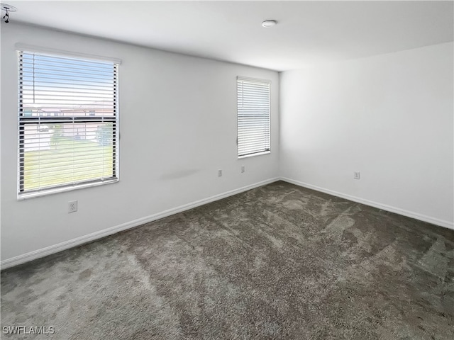 carpeted spare room with plenty of natural light