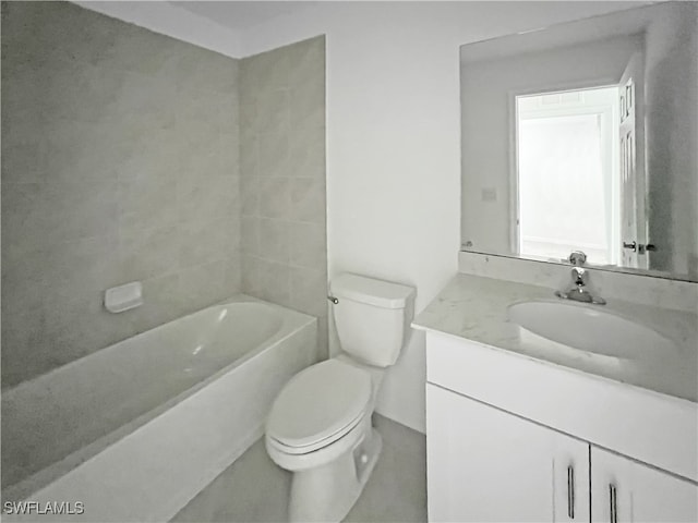 full bathroom featuring vanity, tiled shower / bath, and toilet