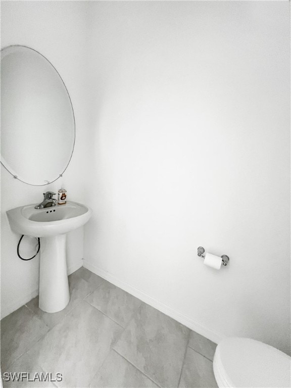 bathroom with tile patterned floors and toilet