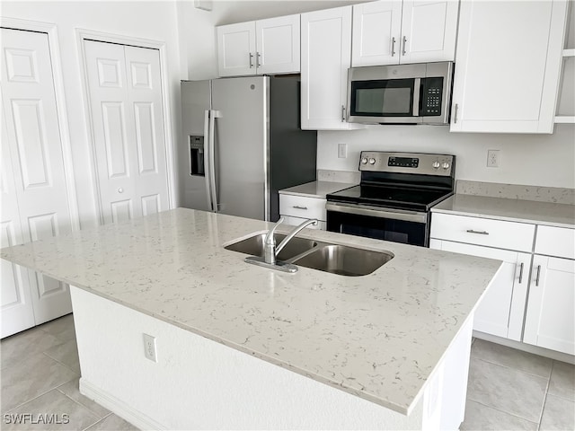 kitchen with stainless steel appliances and an island with sink