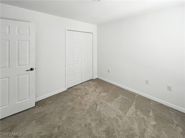 unfurnished bedroom with a closet and carpet floors