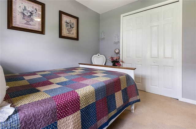 bedroom with light carpet and a closet