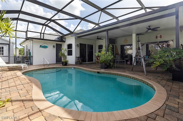 view of pool with a patio, a lanai, and ceiling fan