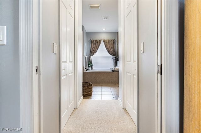 hall with light tile patterned floors