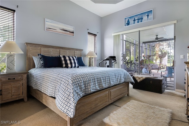 bedroom with multiple windows, access to exterior, and light colored carpet