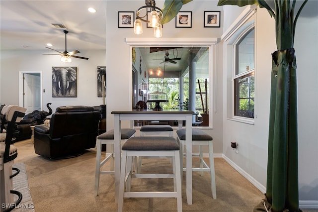 carpeted dining room featuring ceiling fan