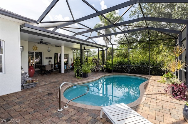 view of pool featuring a lanai, a patio, and ceiling fan