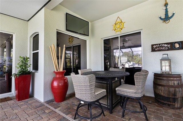 view of patio featuring glass enclosure