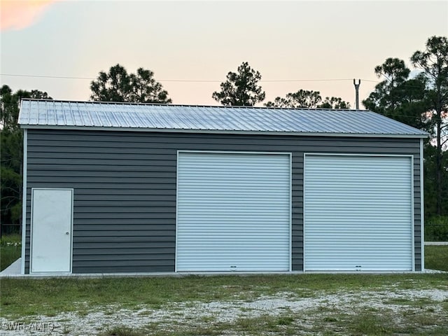 view of garage at dusk