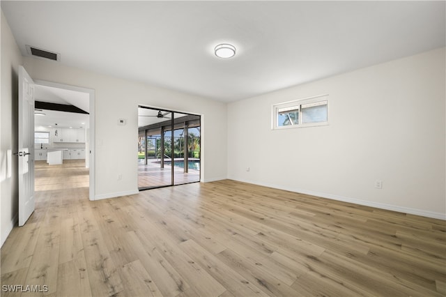 spare room with plenty of natural light and light wood-type flooring