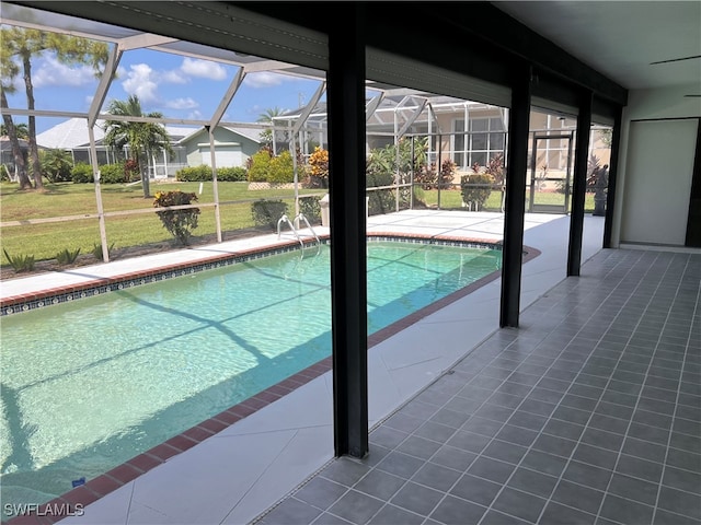 view of swimming pool featuring a patio area and glass enclosure