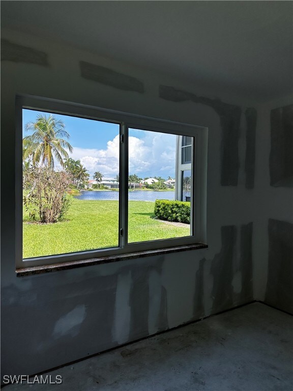 empty room featuring concrete floors and a water view