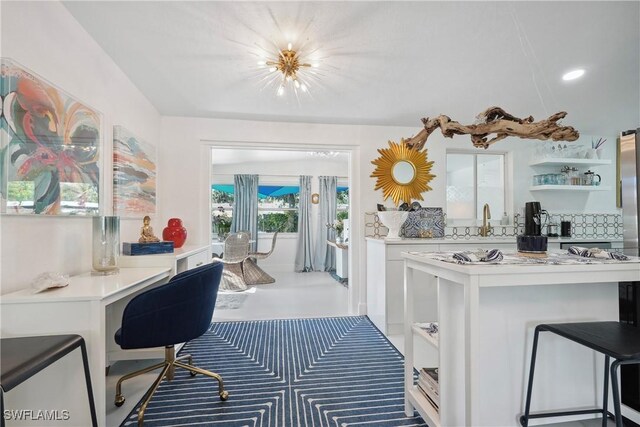 kitchen with white cabinets and a kitchen breakfast bar