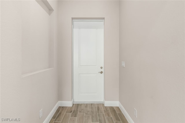 hallway with light hardwood / wood-style flooring