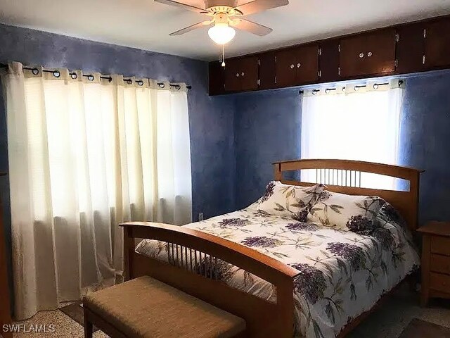 carpeted bedroom featuring ceiling fan