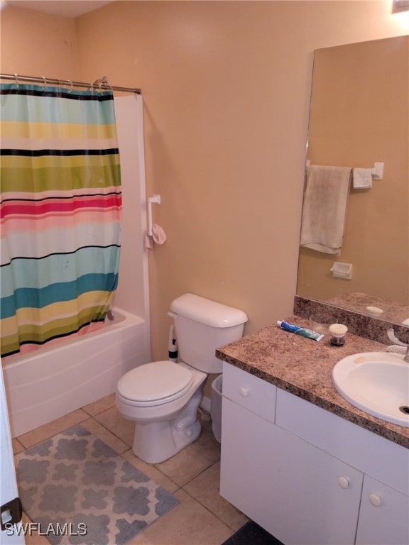 full bathroom with shower / tub combo with curtain, toilet, tile patterned floors, and vanity