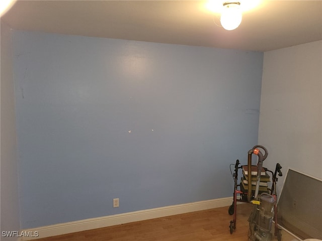 unfurnished room featuring hardwood / wood-style flooring