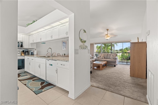 kitchen with white dishwasher, sink, light tile patterned flooring, white cabinetry, and ceiling fan