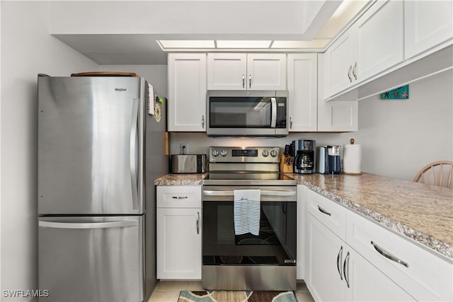 kitchen featuring stainless steel appliances and white cabinets