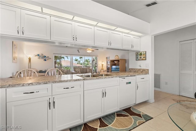 kitchen featuring sink, white cabinetry, white dishwasher, light tile patterned flooring, and kitchen peninsula