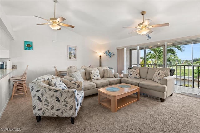 carpeted living room featuring high vaulted ceiling and ceiling fan