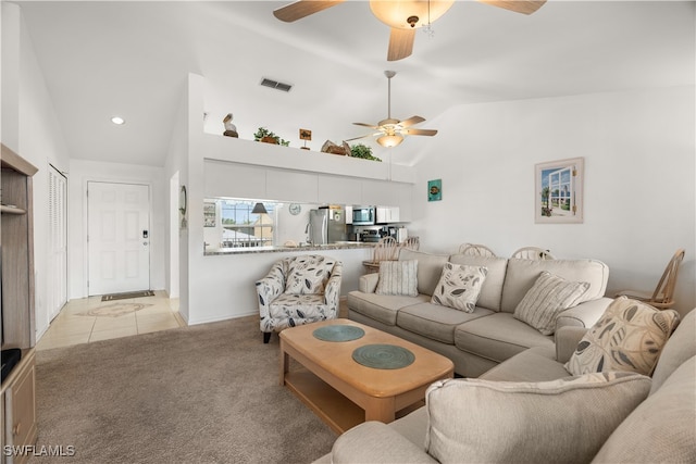 living room with light colored carpet, ceiling fan, and high vaulted ceiling