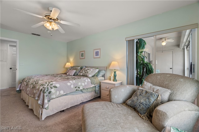 carpeted bedroom featuring ceiling fan and a closet