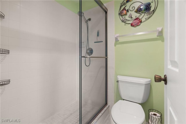 bathroom with toilet and walk in shower