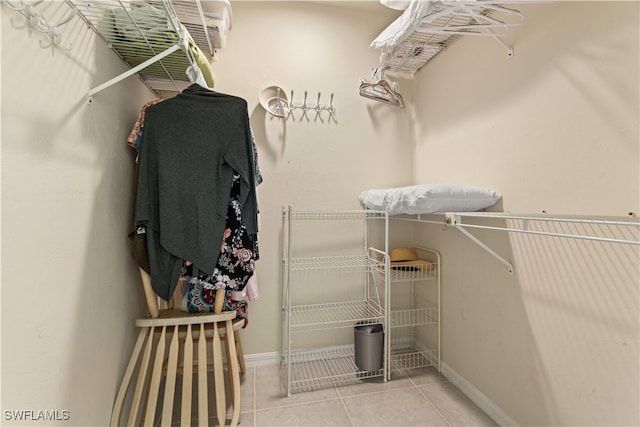 spacious closet with light tile patterned floors