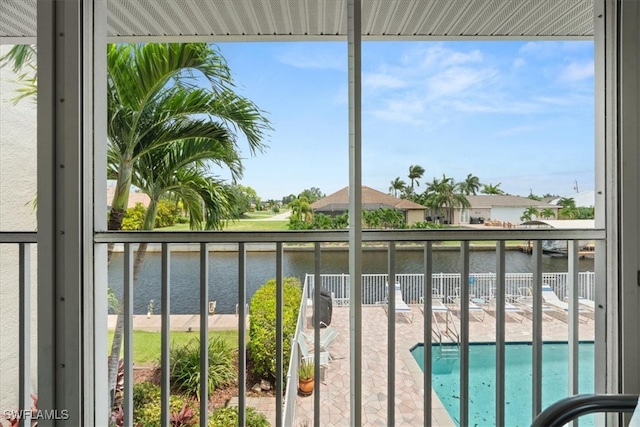 balcony with a water view and a community pool