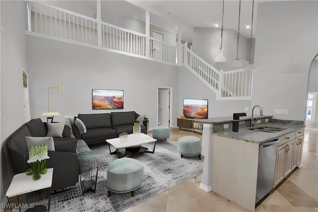 tiled living room featuring a towering ceiling and sink