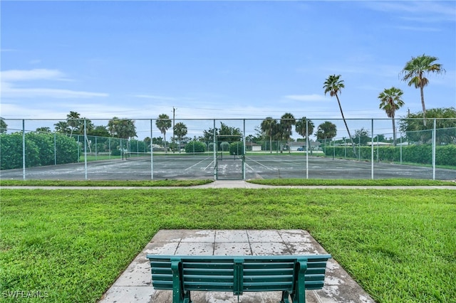 view of tennis court with a lawn