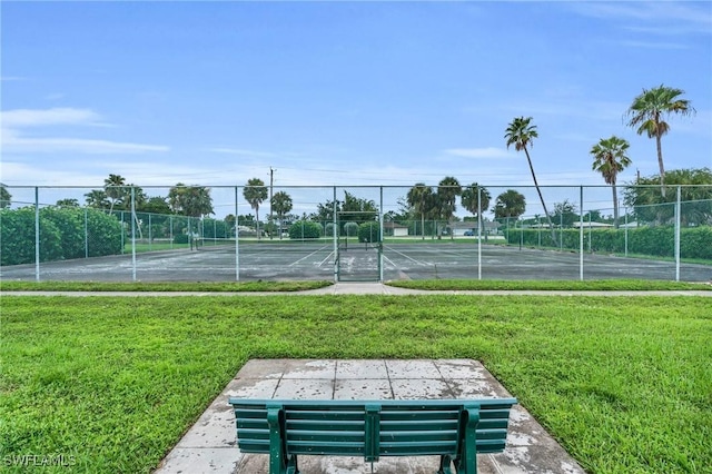 view of sport court with a yard