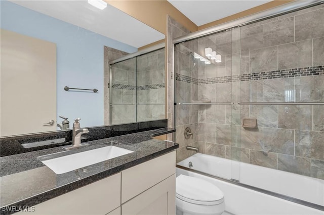 full bathroom with toilet, vanity, and combined bath / shower with glass door