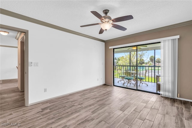 empty room featuring ceiling fan, a textured ceiling, ornamental molding, and hardwood / wood-style floors