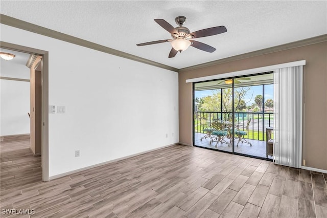 empty room with a textured ceiling, ceiling fan, crown molding, and light hardwood / wood-style floors