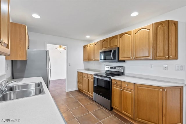 kitchen with stainless steel appliances, sink, tile patterned flooring, and ceiling fan