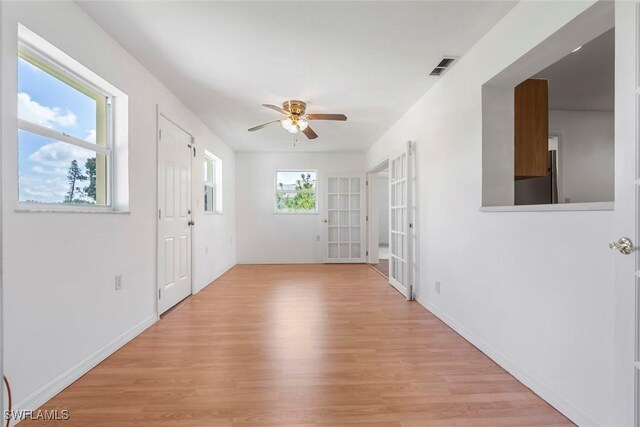 interior space with ceiling fan and light hardwood / wood-style flooring