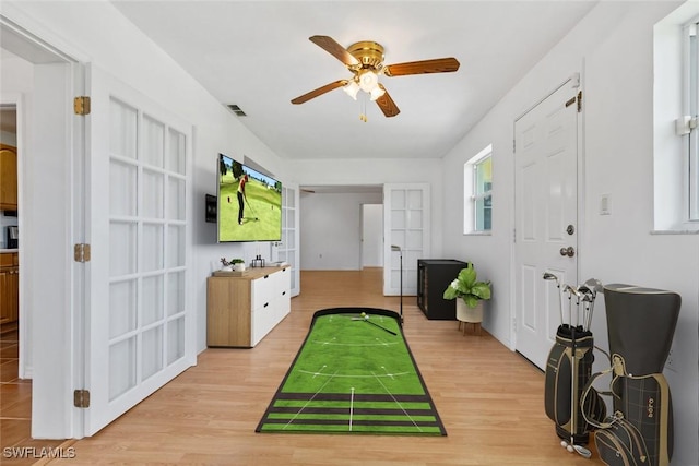 game room with ceiling fan, visible vents, and light wood-style flooring