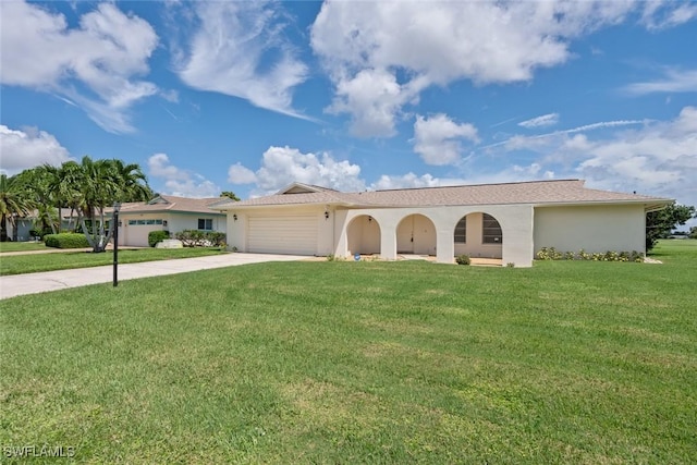 view of front of property with an attached garage, stucco siding, concrete driveway, and a front yard